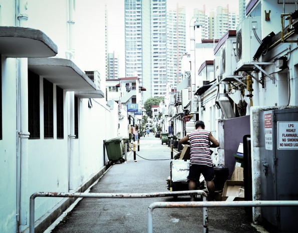 MODERNISATION: The only constant in this world is change.The edifice in the background is a stark contrast to the shophouses that the residents in Tiong Bahru used to see. Some cope with modernisation by collecting “memories” left behind in garbage bins and old cardboard boxes. (Photo: Sariyanto Slamat)  