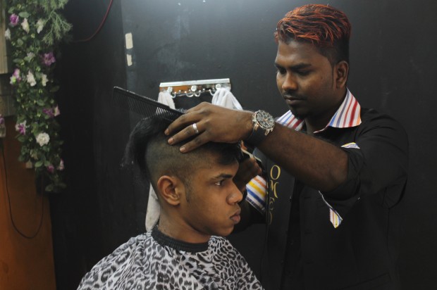 A FANCY CUT: A customer gets his hair "designed" by Mr Rengan, the creative barber. 