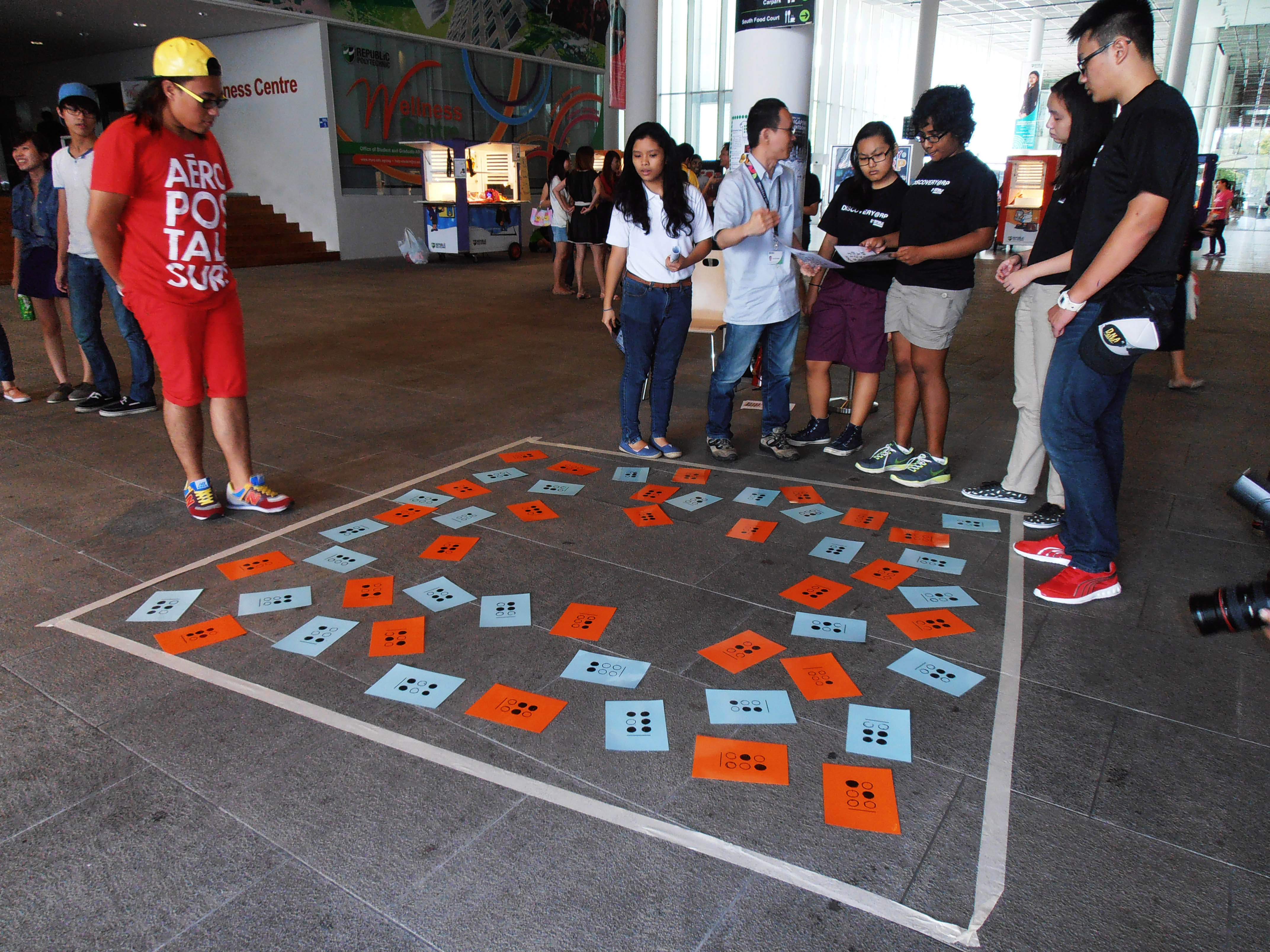 BRAILLE TIME BOMB: A group of students are ready to start their mission at the Braille Time Bomb station by CEC (Centre for Enterprise and Communication). They were tasked to match the letters according to those on the piece of paper given to them. (Photo: Jamie Loo)