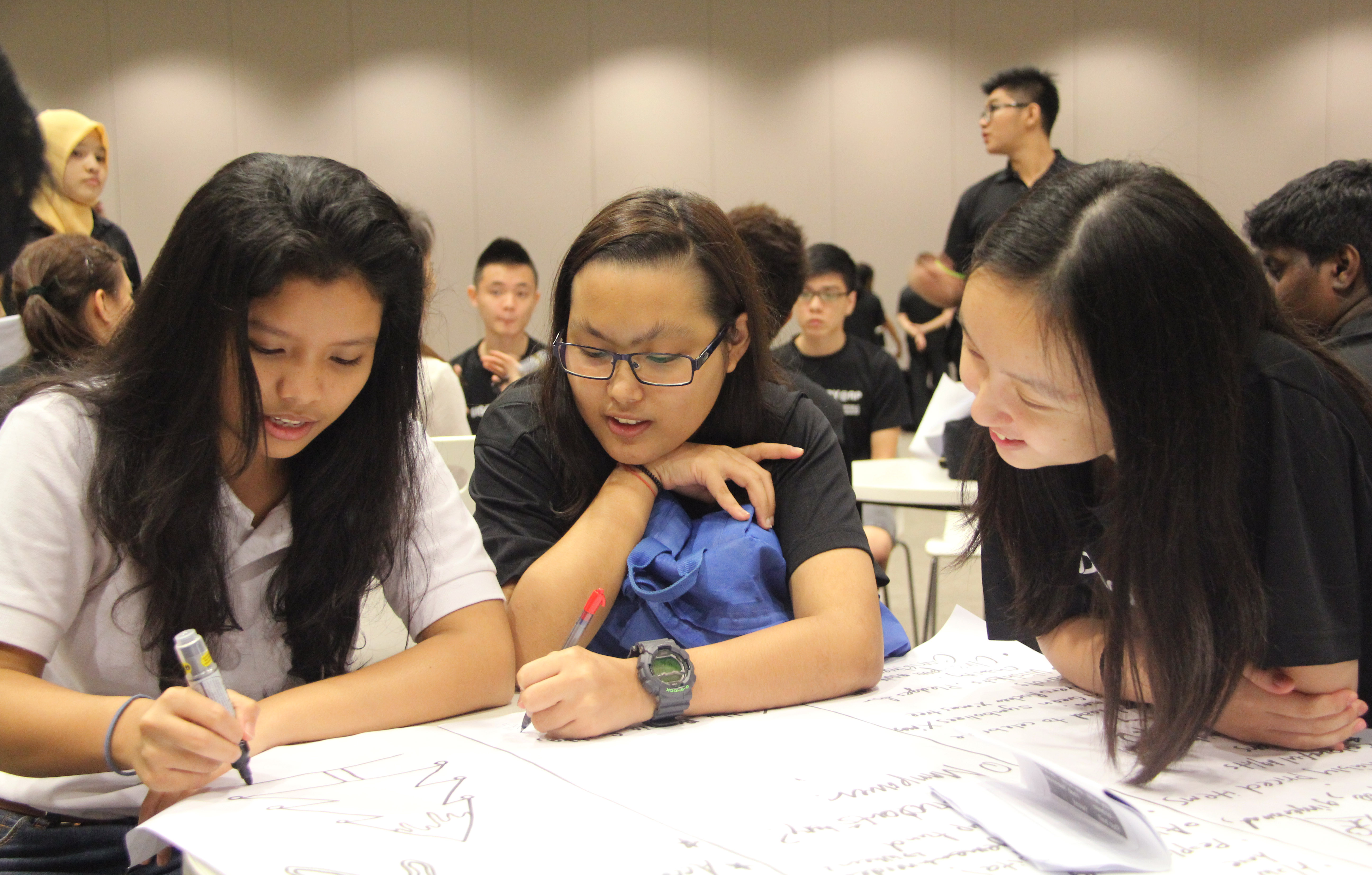 PROBLEMS AND PDTS: A student leader guides secondary school students into completing their PDT. (Photo: Ryan Lim)