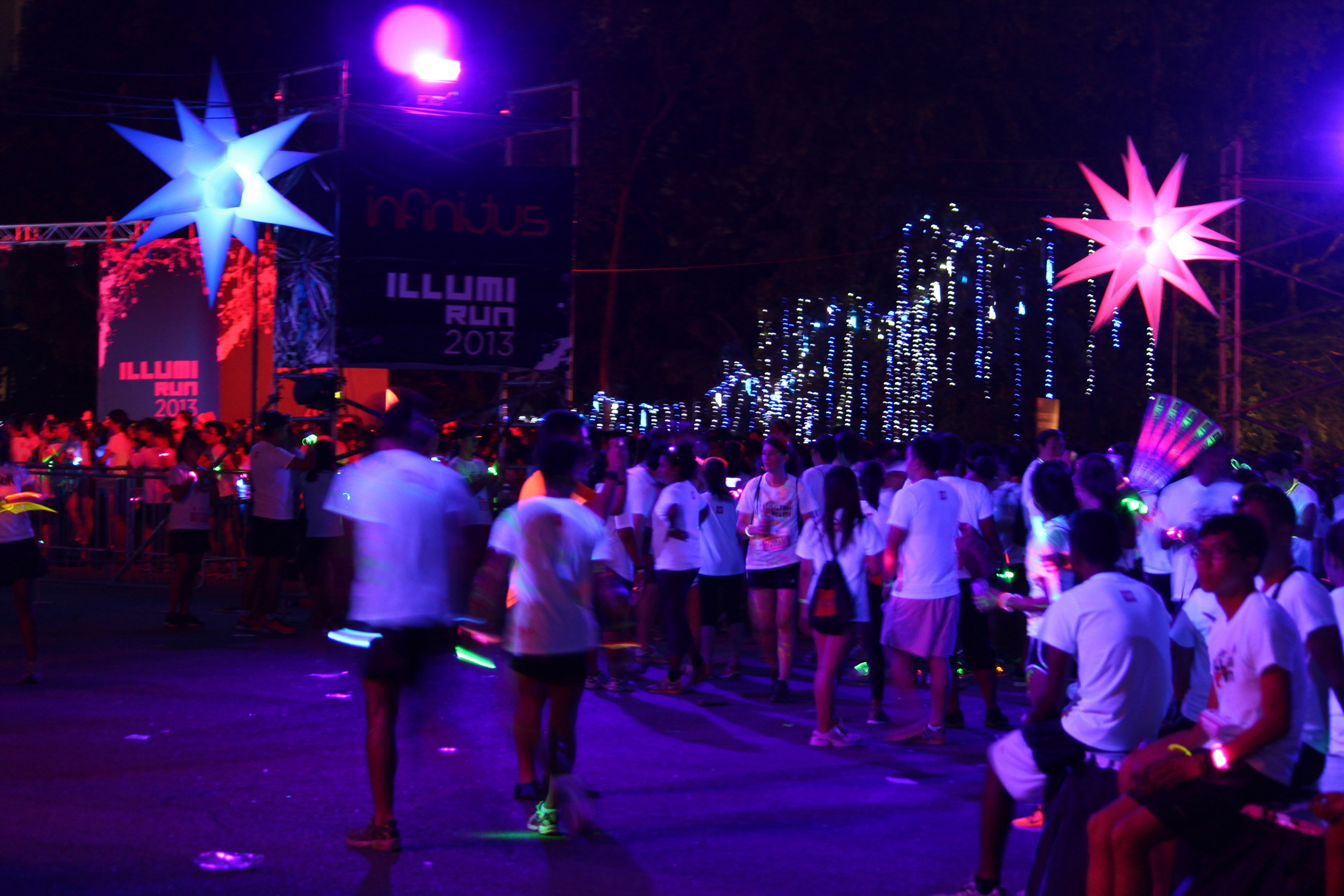 RUNNING IN THE DARK: Close to 10,000 people took part in the inaugural run, accessorising themselves with light sticks and other items that caught attention in the dark of the night. (Photo: Geneieve Teo)