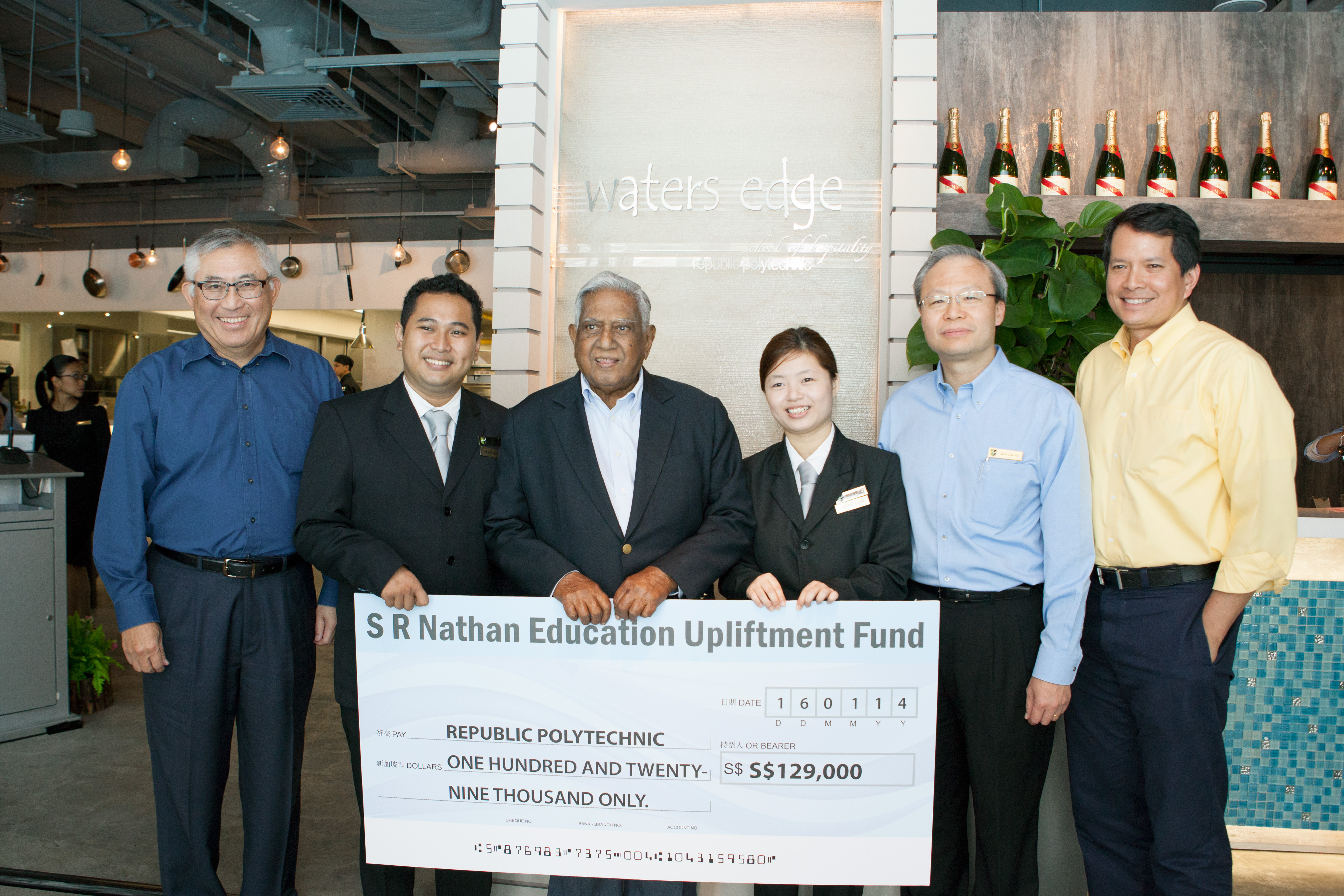 GENEROUS SPIRIT: Mr S R Nathan presents a $129,000 cheque to RP that will help students who struggle with finances. The cheque presentation ceremony was held at the student-run restaurant, Waters Edge. Photo: Republic Polytechnic