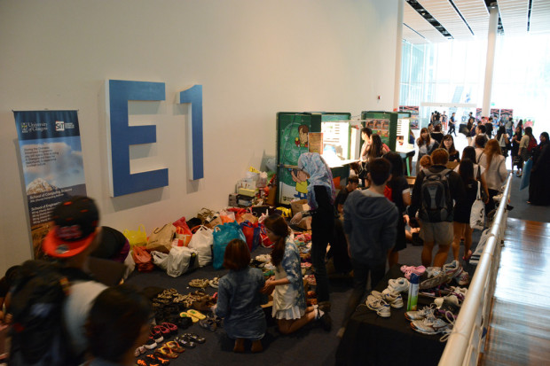 PILING ON THE FOOTWEAR: Scores of crowds at the E1 booth waiting to donate their shoes. (Photo: Ryan Lim)