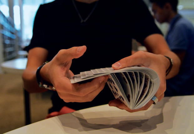 Everyday I’m Shuffling: Magic IG’s Vice-President, Desmond Ho Hou Chun, showing one of the many ways to shuffle cards. (PHOTO: Nur Humaira Wahab)