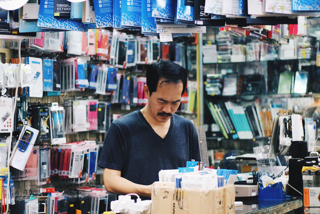 Phoney Business: Ah B, owner of Sim Guan electrical shop has sold everything from washing machines to phones in his 34 years of business, which makes leaving the premises all the more harder for him.(Photo: Sabrina Muhleseddin)