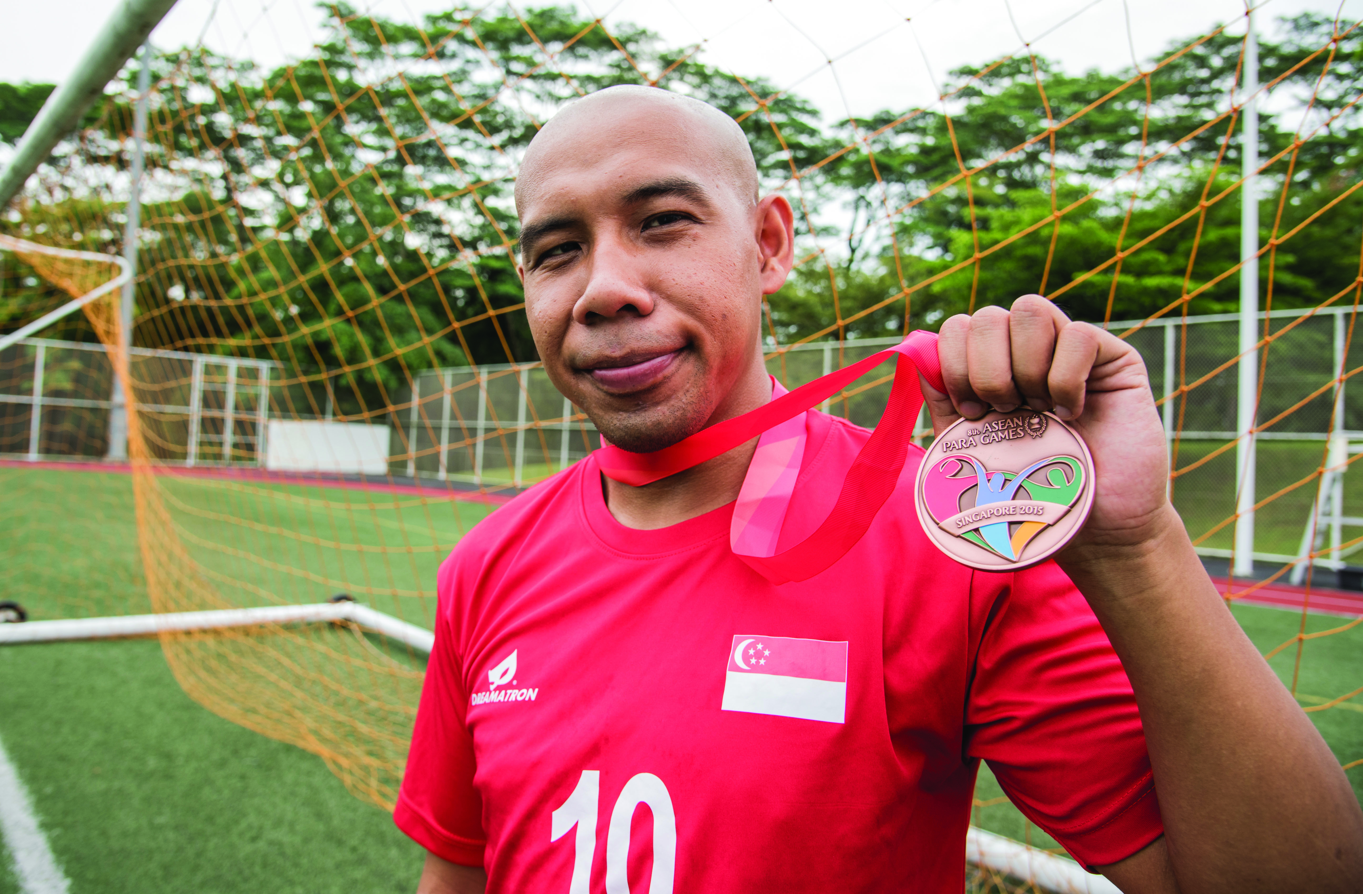 INTO THE HISTORY BOOKS: Being the first Singaporean to score a hat-trick at the new National Stadium, Khairul Anwar, 29, has overcome disability to become a cult hero in local football. PHOTO: Ken Lu