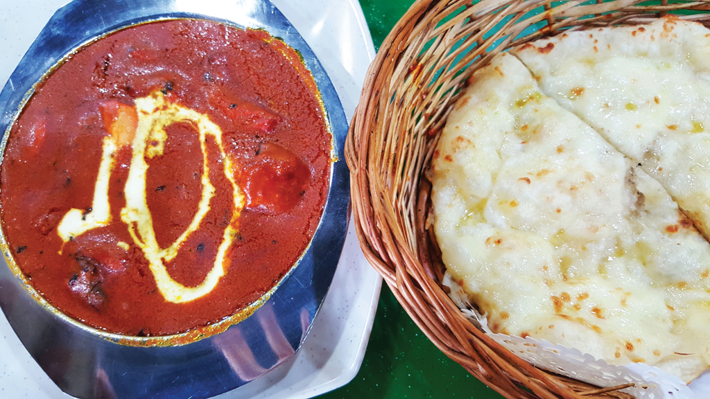 Filling for two: The butter chicken accompanying the cheese naan is one reason why this meal should be shared by a group.