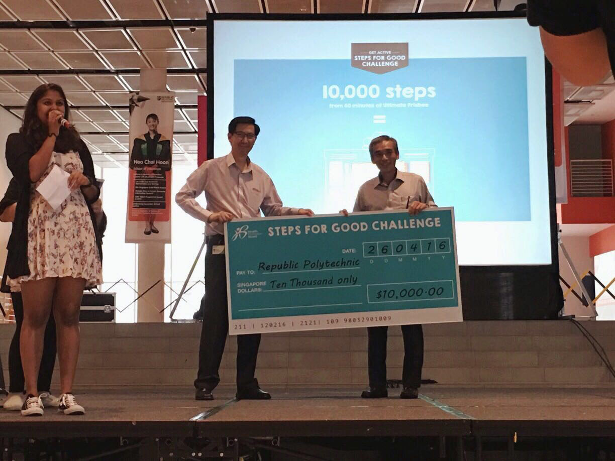 Challenge accepted: Republic Polytechnic’s Senior Director of Student Services and Planning, Mr Fong Yew Chan, (left) receiving a cheque of $10,000 from a HPB representative for the polytechnic’s efforts in the Steps For Good Challenge. The money will be contributed to RP’s education fund. (Photo: OSG)
